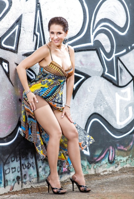 Roni has style and she knows how to pose naked against the wall